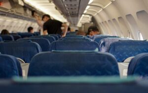 A group of travelers settling in the plane cabin for take off