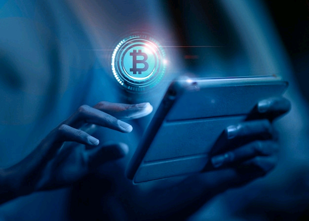 a person using a tablet with a Bitcoin icon floating above it.