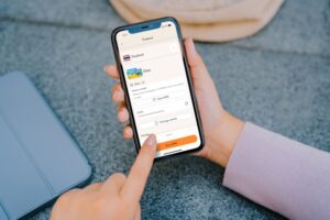 Person using a smartphone with travel app open
